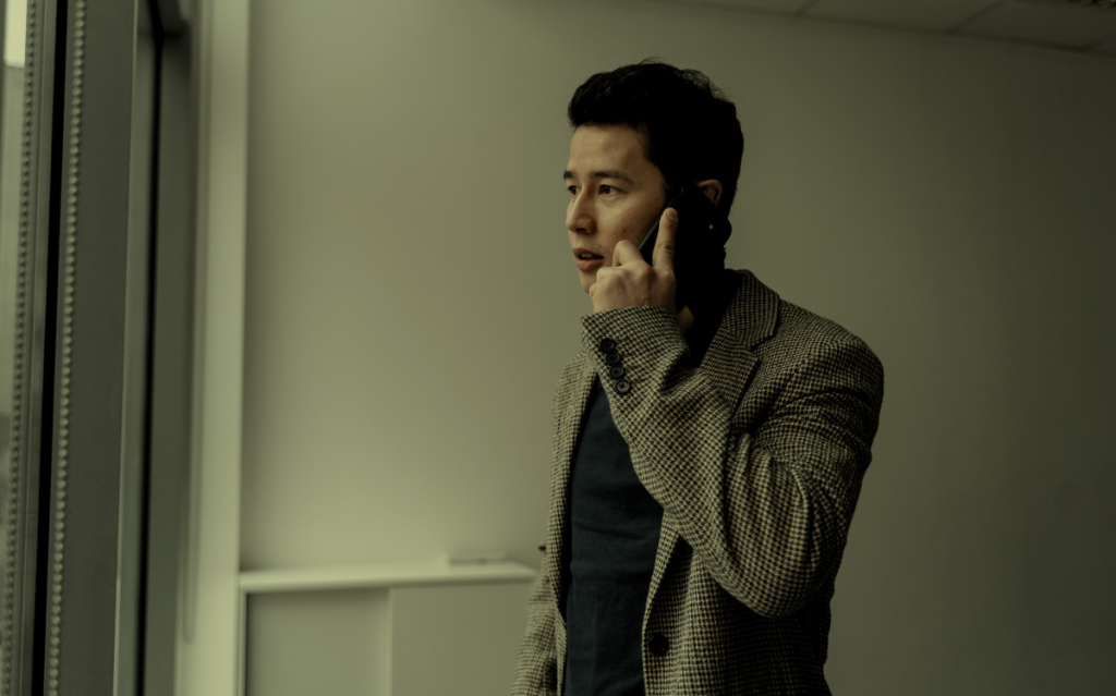 A man in casual attire speaking on a mobile device, suggesting the use of smartphones for communication or personal tasks.